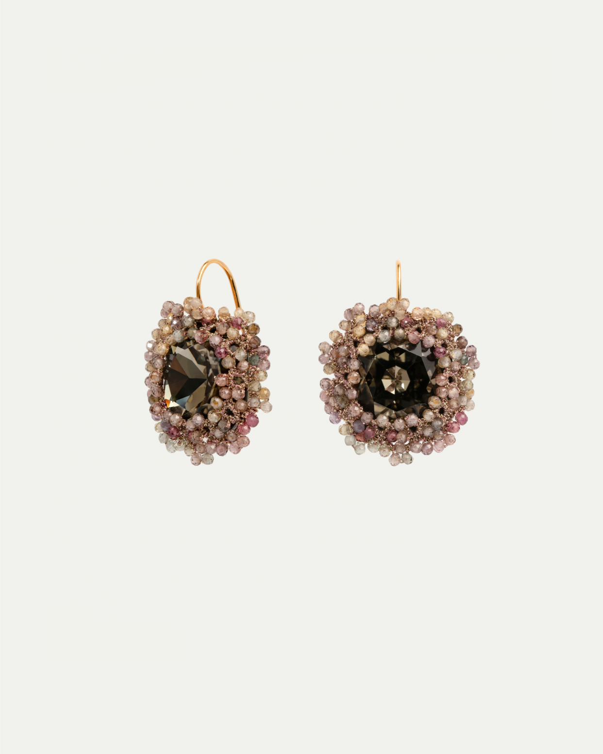 Multicolor silk earrings with intricate beadwork, central dark gemstone, and gold hooks.