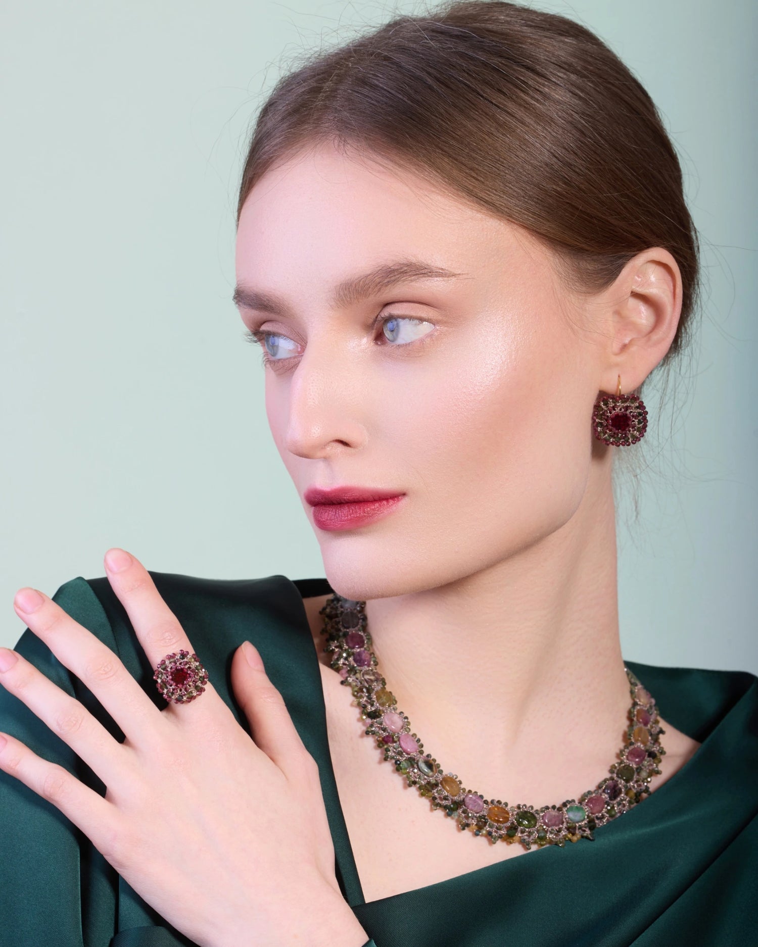 Red ARACELI RING with silk, crystal, and garnet detail on finger, elegant texture, available in sizes 50 and 55.