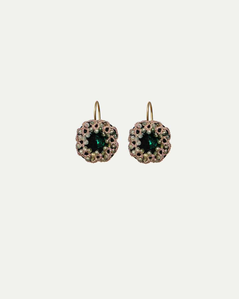 Green DANI earrings with gold hooks, featuring central green stones surrounded by intricate beaded detailing.