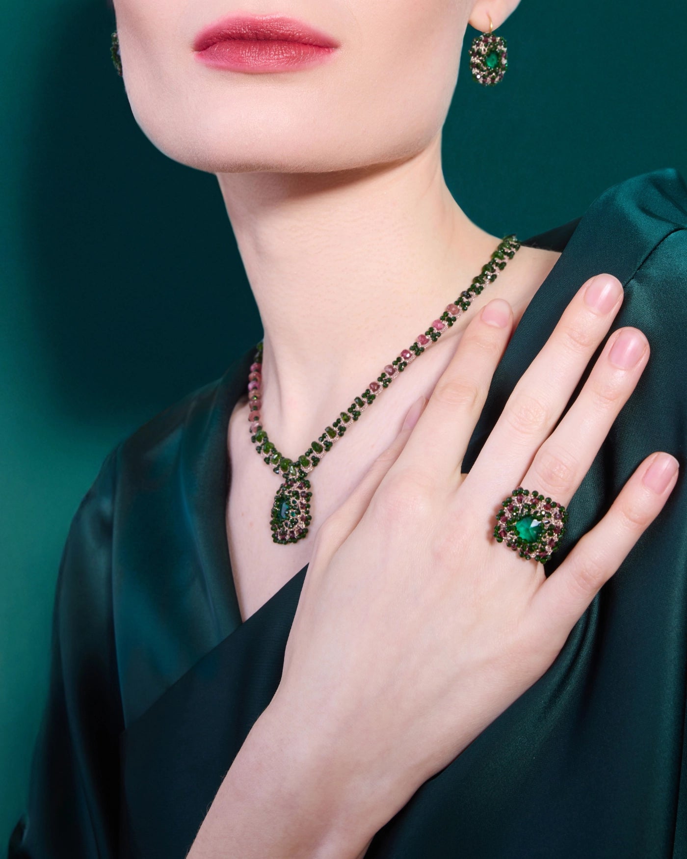 Delphine ring in green, emerald cut stone, ornate setting, worn on hand, matches necklace and earrings.