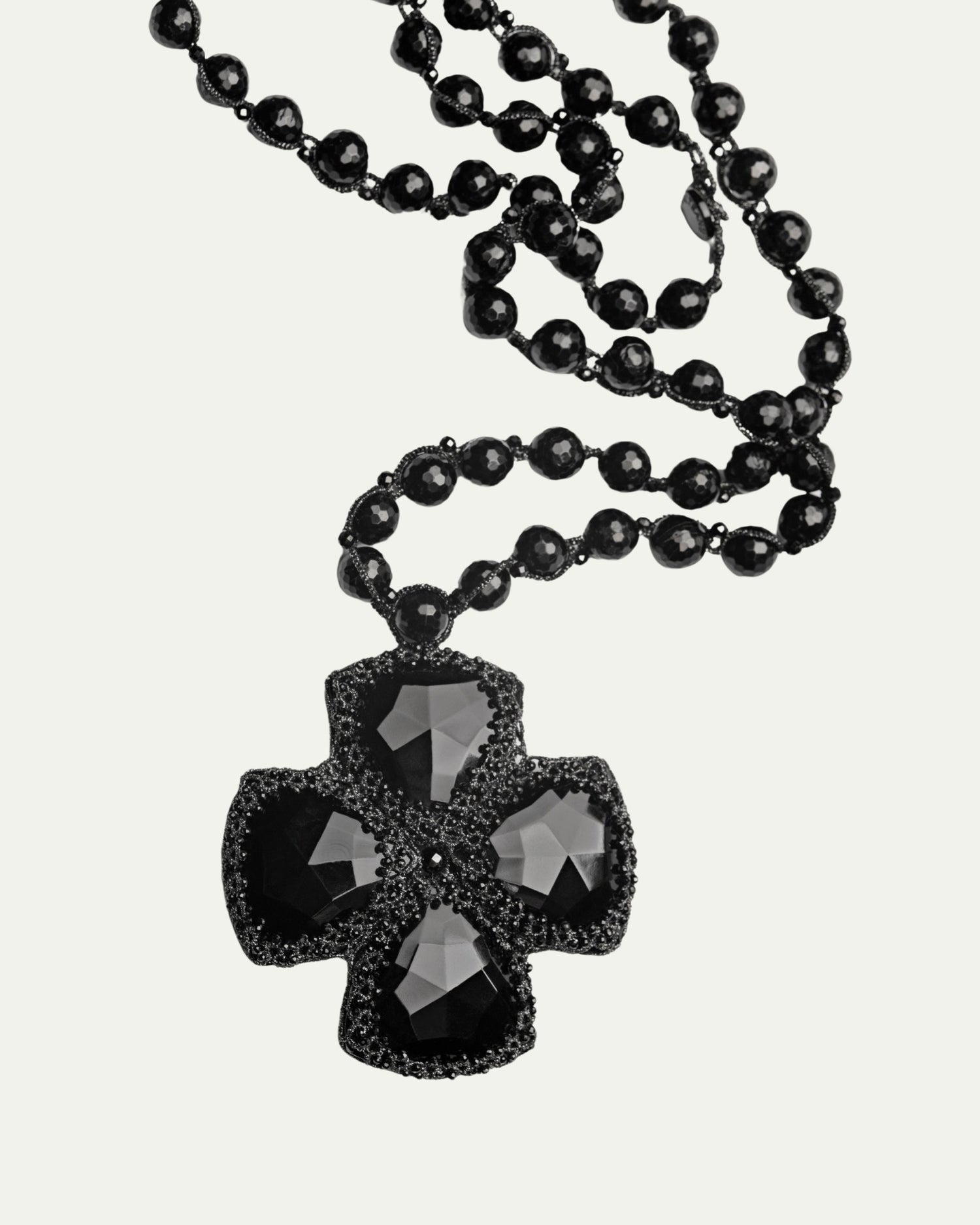 Black DITA PENDANT with faceted glass beads and intricate silk detailing displayed in close-up view.