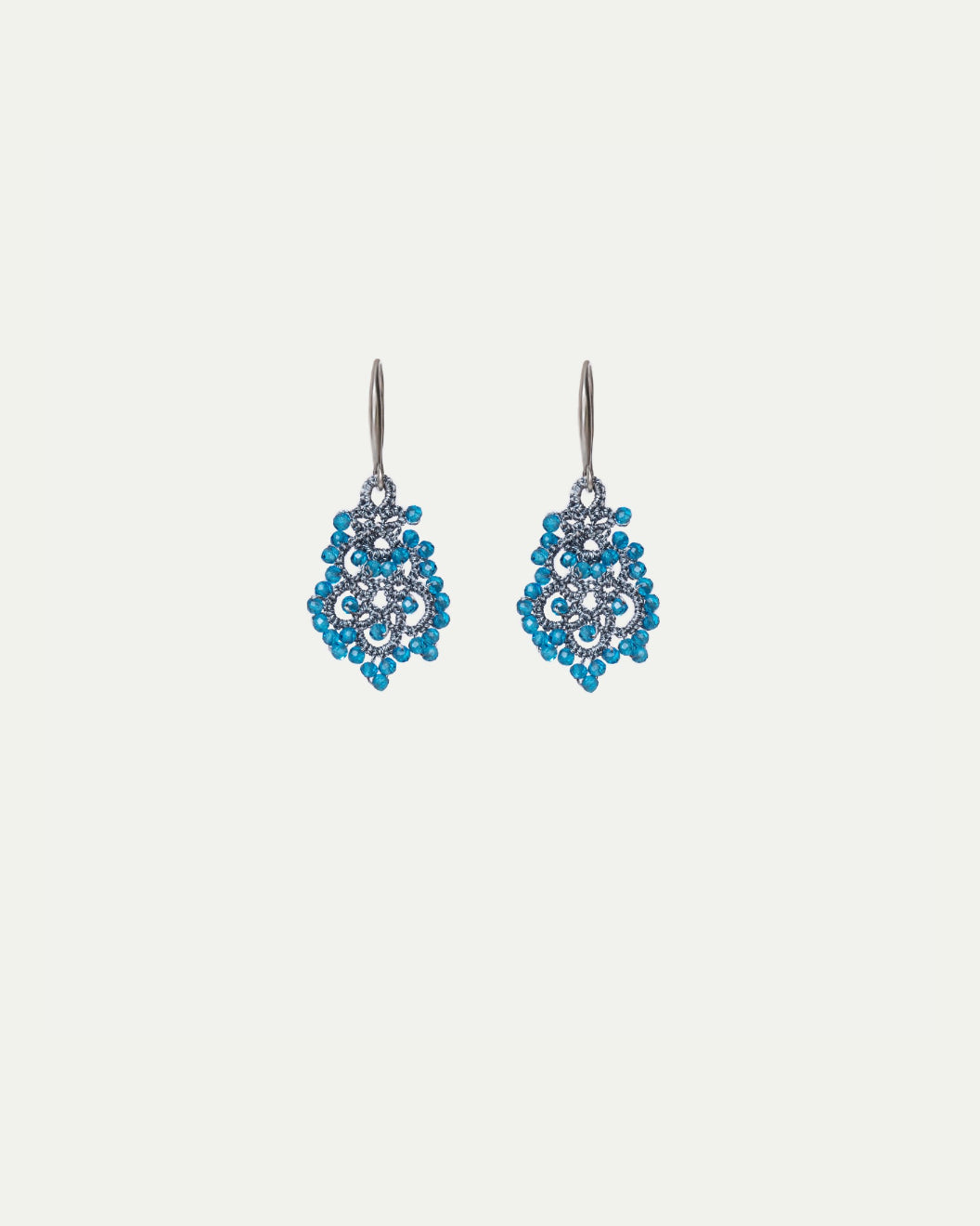 Dora earrings with blue apatite gemstones, silk threads, and gold-plated silver hooks.
