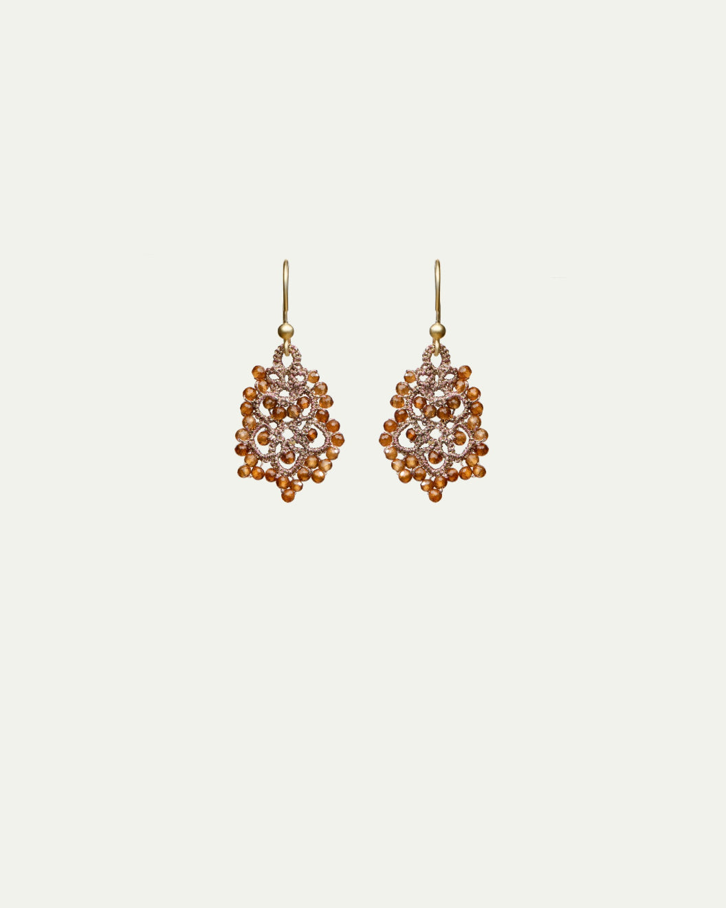 Dora earrings with orange garnet gemstones, silk, gold-plated silver hooks, intricate design.