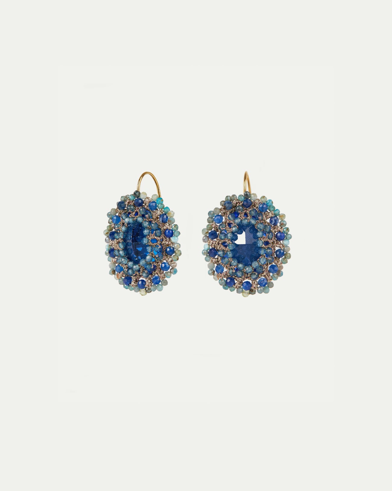 Gold hoop earrings with blue kyanite and crystal beads, featuring silk and silver accents for intricate detailing.