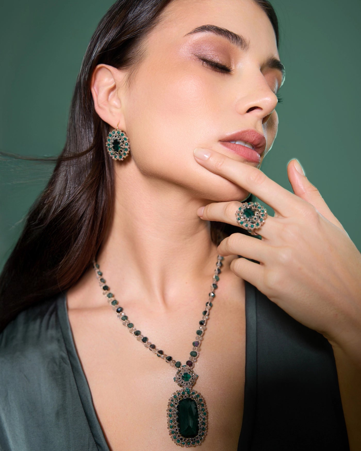 Green ECATERINA RING with emerald, tourmaline, silk detailing; crystal accents, shown on hand.