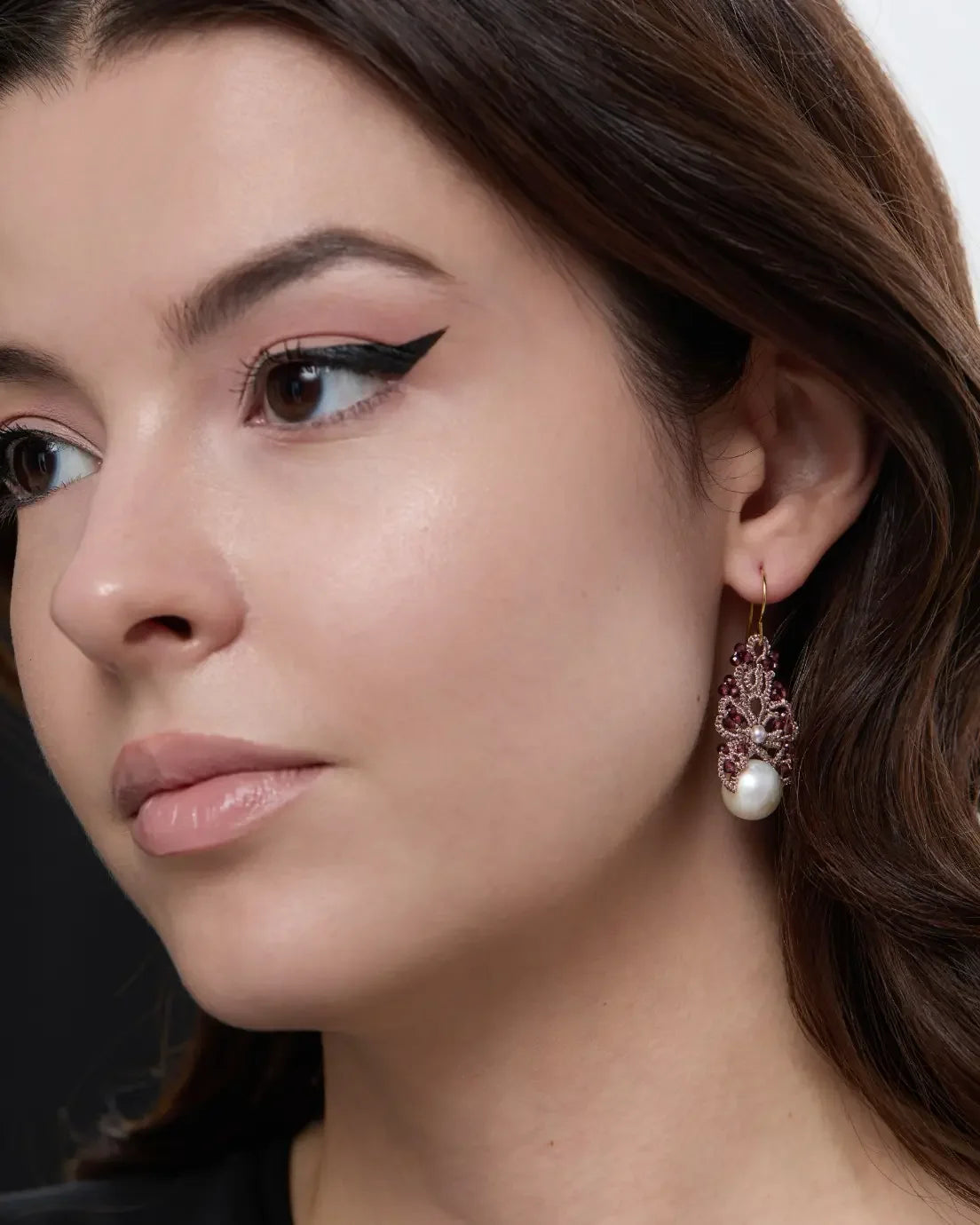 Red silk and gold earrings with pearls and freshwater pearl detail, worn by model.