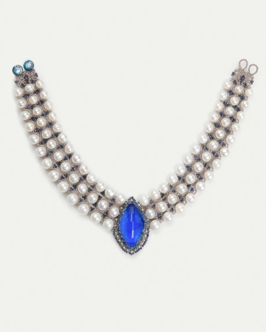 Blue kyanite and freshwater pearl necklace with silk strands and intricate detailing.