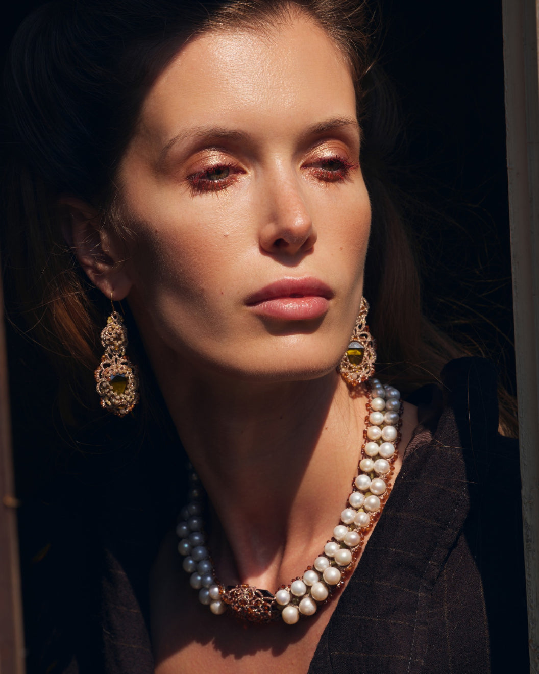 Gold INESSE earrings with intricate silk and crystal details, featuring garnet accents and silver components.