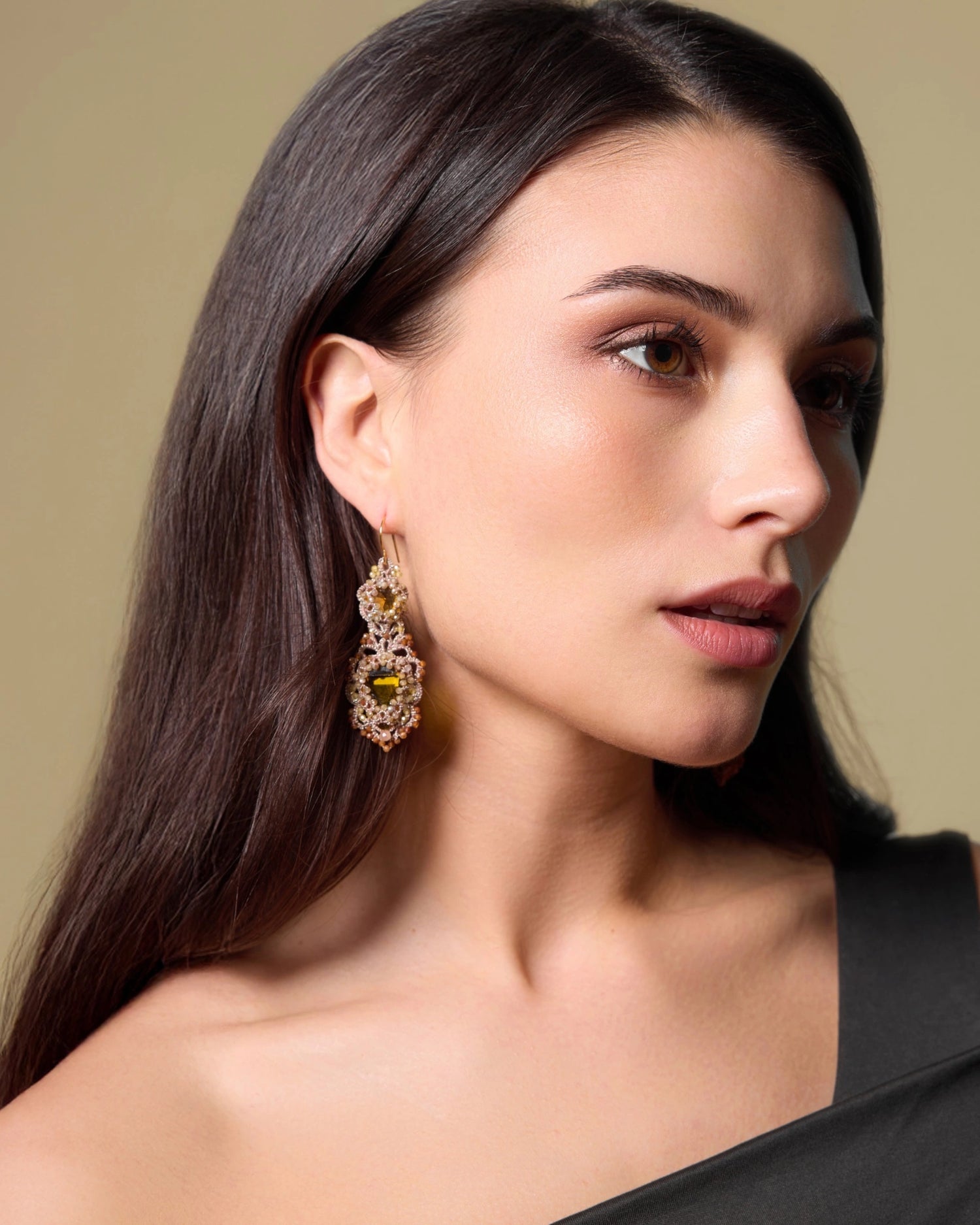 Gold INESSE earrings with intricate silk, silver, crystal details, featuring a garnet centerpiece.