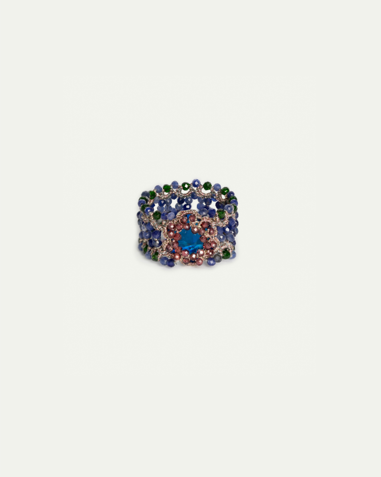 Multicolor Linda Ring, intricate design, gemstone setting, blue, pink stones, green accents, side view.