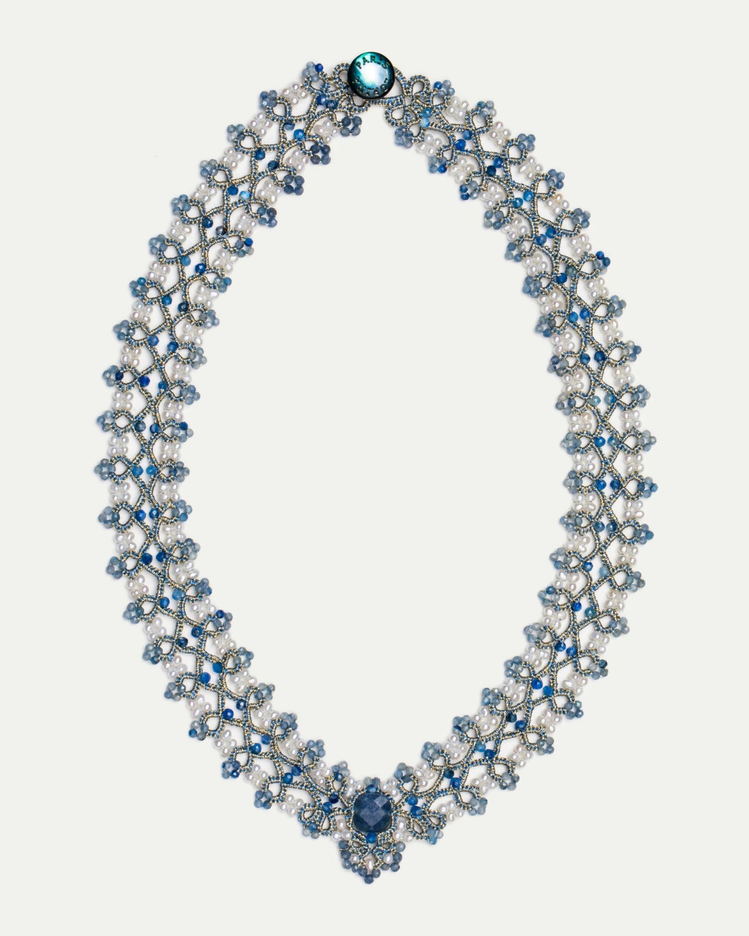Blue silk necklace with freshwater pearls and kyanite, intricate lattice design, detailed craftsmanship.