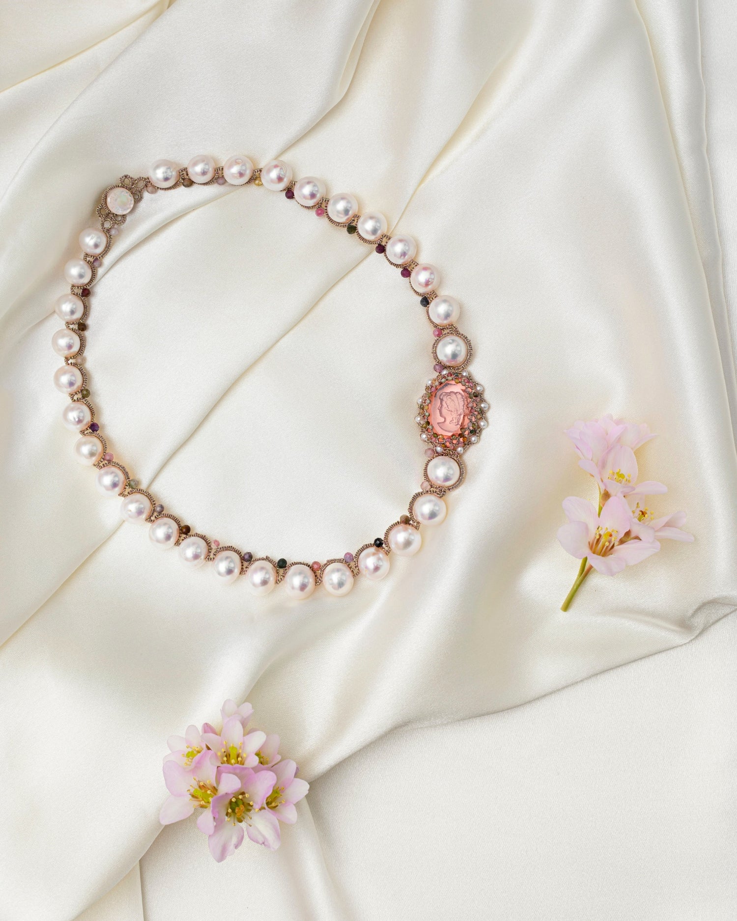 SELENE NECKLACE with rose tourmaline gemstones, freshwater pearls, crystals on silk background.