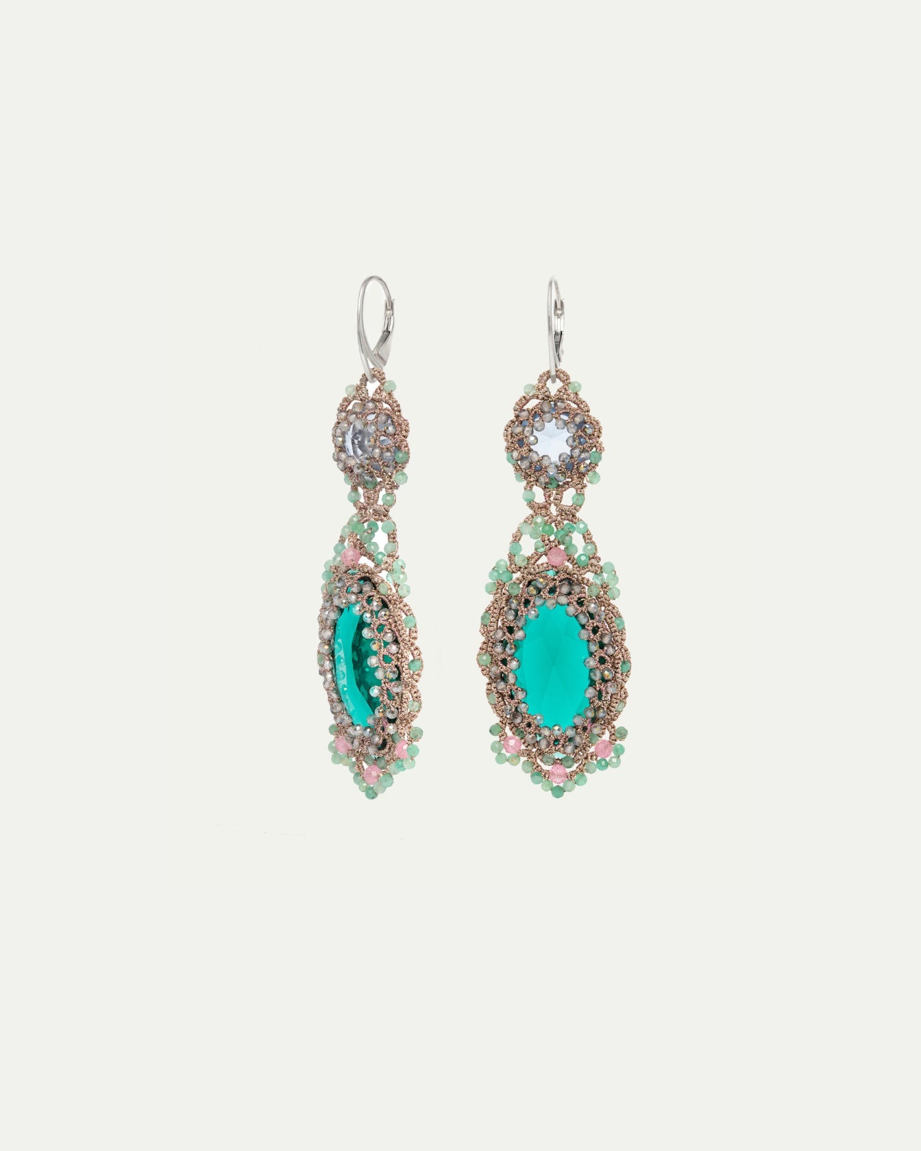 Green silk earrings with silver hooks, crystal, emerald, topaz details; intricate texture and vibrant color.