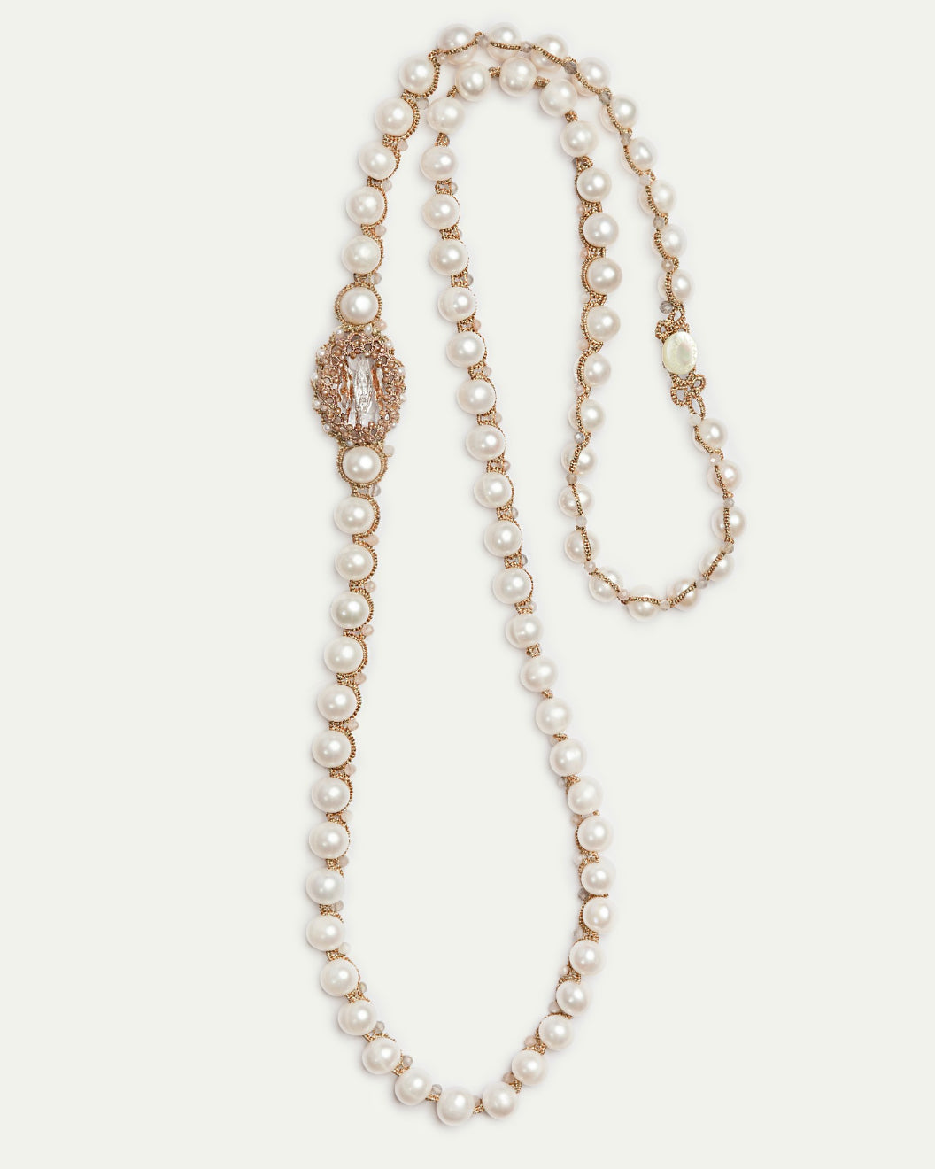 Gold pendant with pearls and crystals detail, showing intricate texture and elegant design elements.
