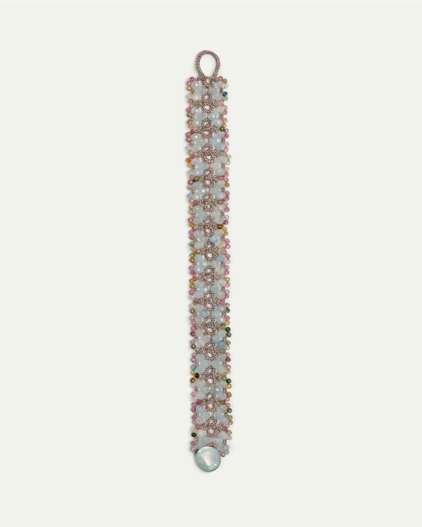 TANYA BRACELET with aquamarine, tourmaline, and silk in blue, embellished with mother of pearl button.