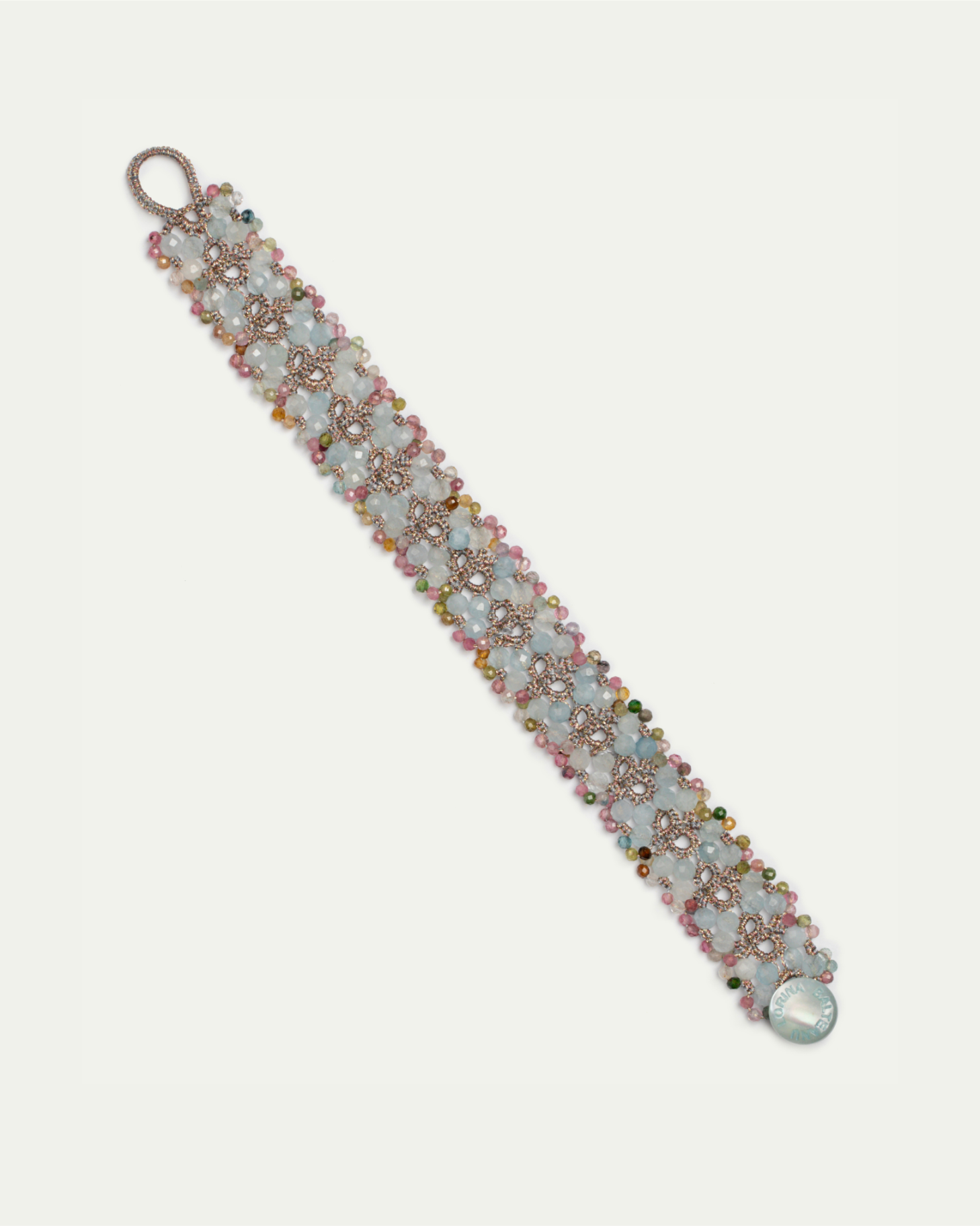 Blue and multicolored beaded bracelet with intricate floral patterns, featuring gemstones and metal embellishments.