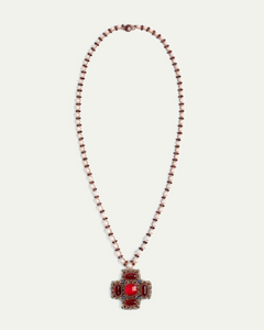 Red pendant necklace with pearl and brown beaded chain, showcasing intricate side view design details.