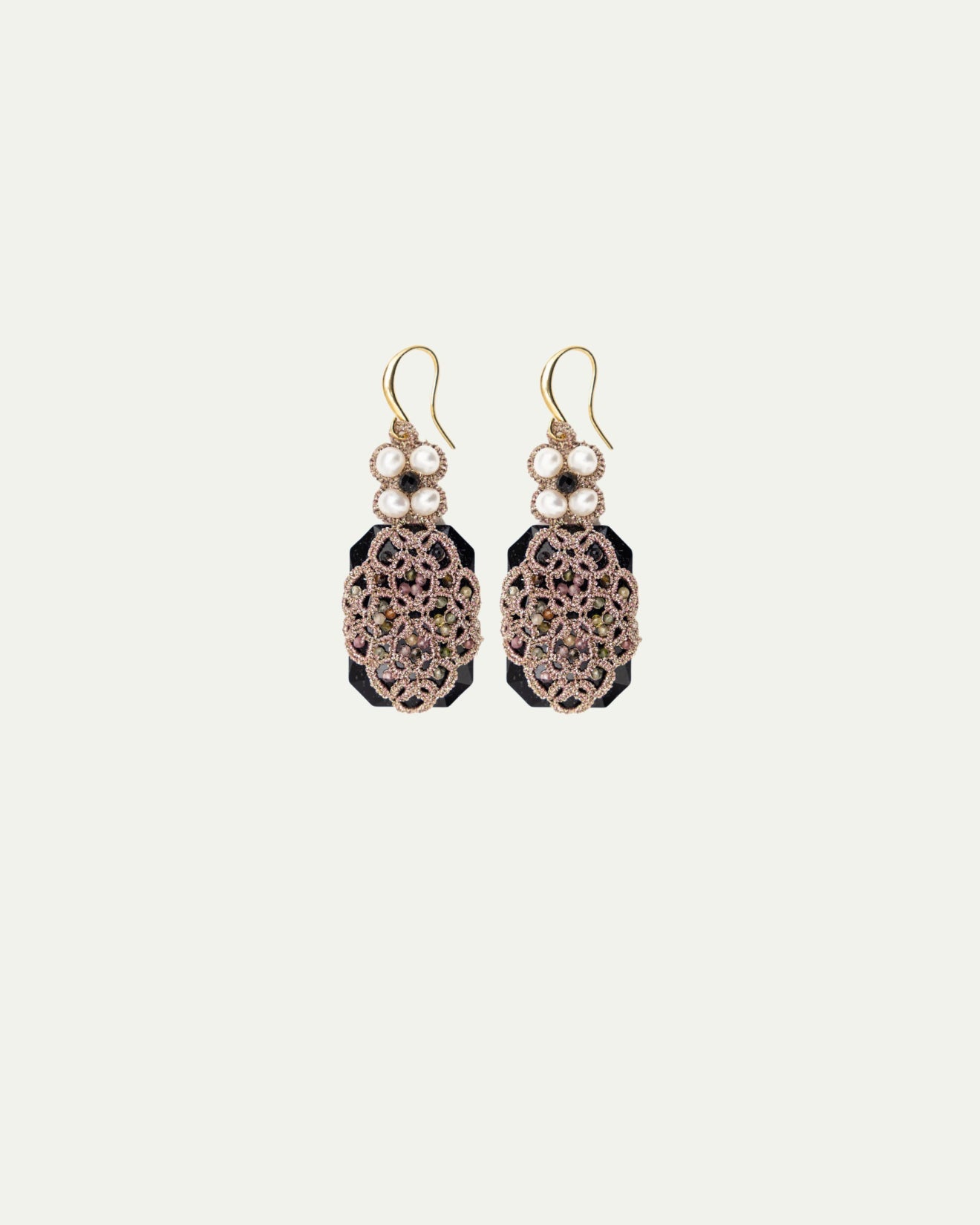 Gold hook earrings with intricate pink lace overlay, pearl accents, and a black base in a floral motif.