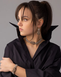 Silk and gold Bari earrings with white freshwater pearls, intricate detail, worn by model in black attire.