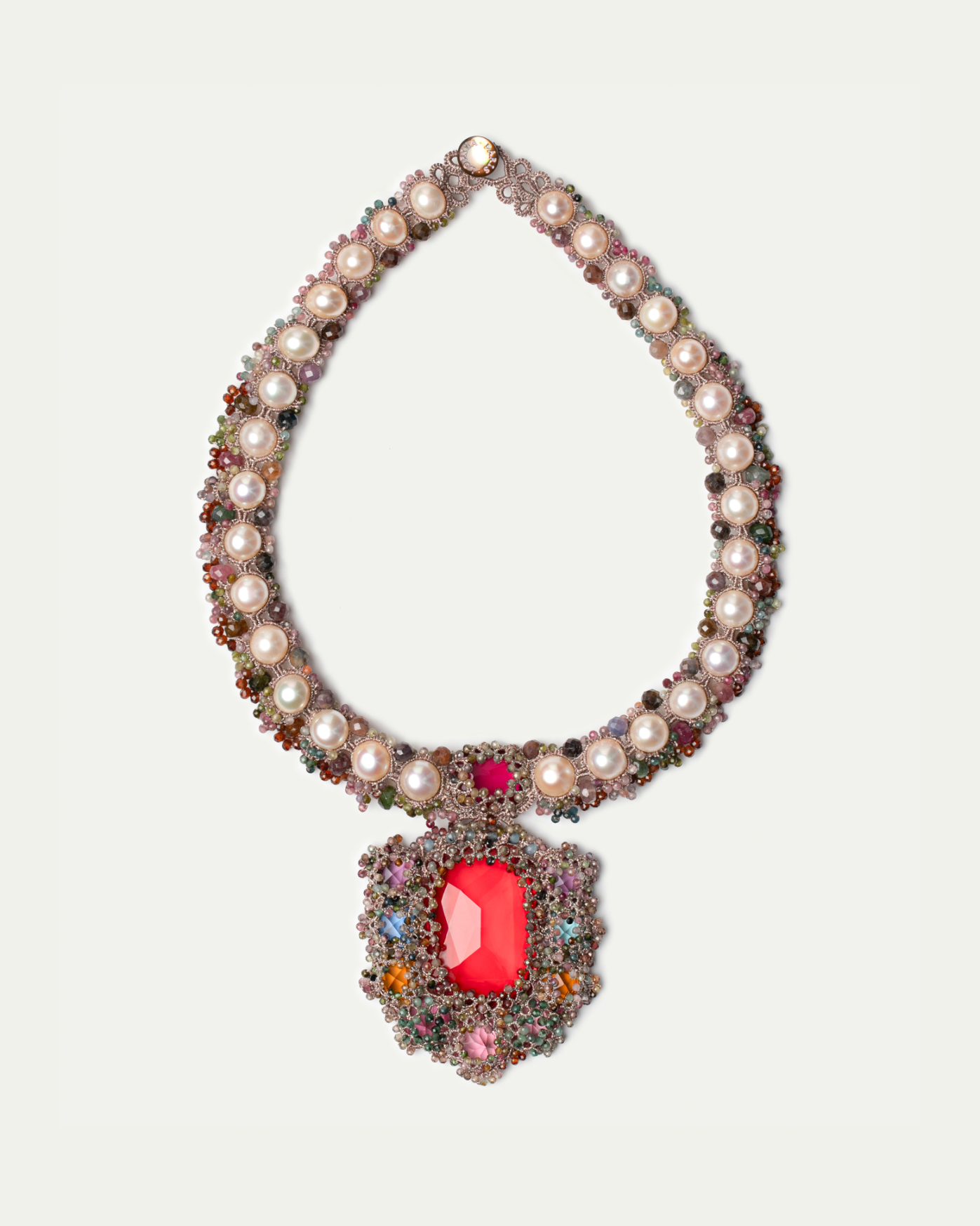 Elegant necklace with pearls, multicolor gemstones, and large red pendant, featuring intricate detailing.