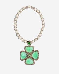 Cassiopeia necklace with green gemstone, pearl beads, silver accents, cross-shaped pendant side view.