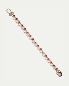 Silk bracelet with white freshwater pearls, garnet beads, and textured red silk details in small size.