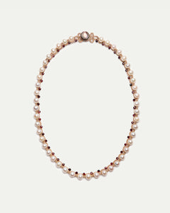 Red and white Dallas necklace with pearls and gemstones on elegant chain, side view.