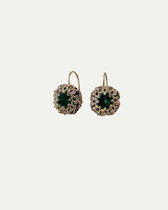 Gold hook earrings with green sapphire center, silk edge, crystal accents, silver detailing, intricate texture.