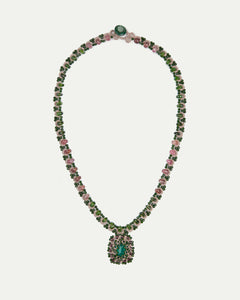 Green Delphine necklace with intricate beads and gemstones, featuring an emerald pendant and pink accents, side view.