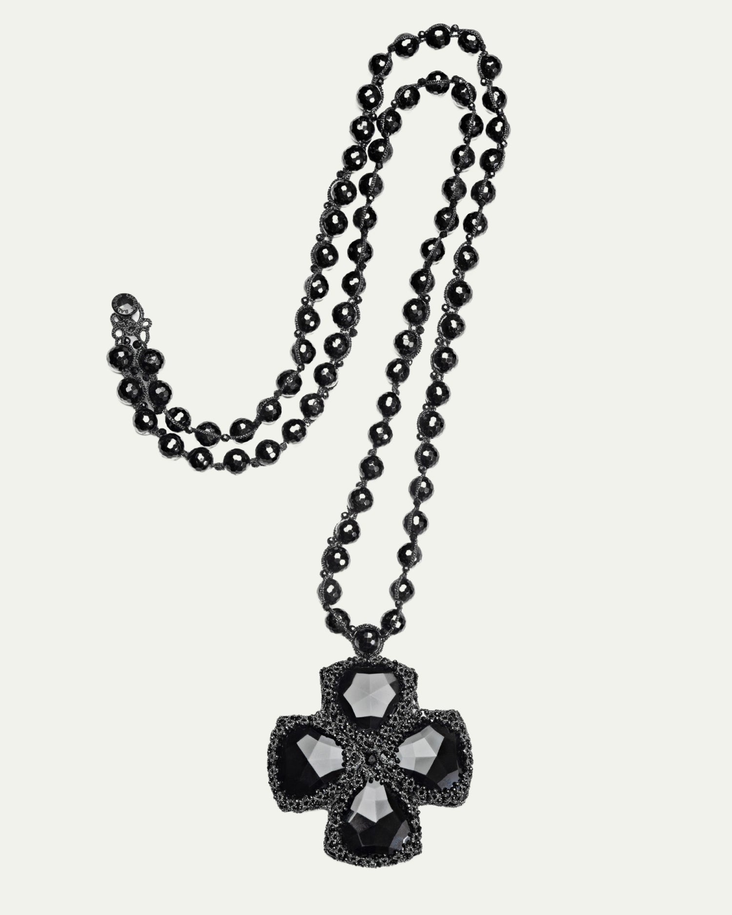 Black DITA PENDANT with faceted gems on beaded chain, side view, intricate design detail.