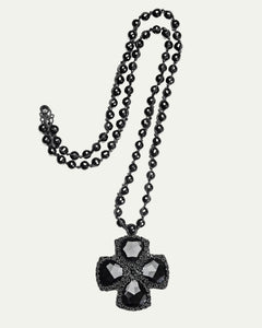 Black DITA PENDANT with faceted gems on beaded chain, side view, intricate design detail.
