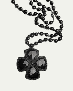 Black DITA PENDANT with faceted glass beads and intricate silk detailing displayed in close-up view.