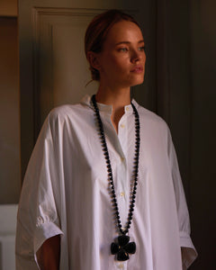 Black silk, pearl, glass DITA pendant, detailed beaded design, worn with a white blouse, elegant texture