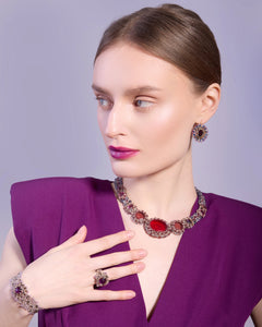 Multicolor ECATERINA earrings with intricate gemstone design, shown from side angle, worn with matching necklace.