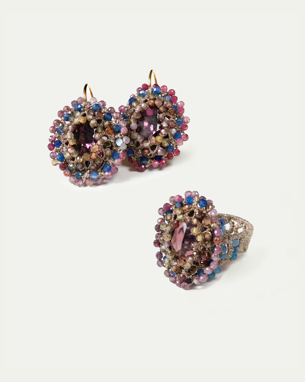 Multicolor ECATERINA RING with purple gemstone, surrounded by pink, blue beads, textured band, side view.