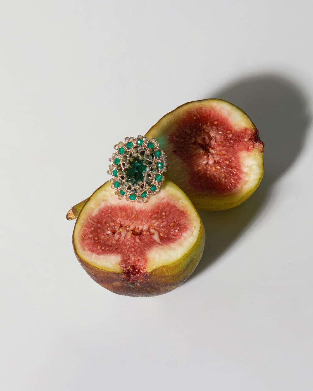 ECATERINA RING with green tourmaline, emerald, zircon gemstones, on fig, featuring silk and crystal.