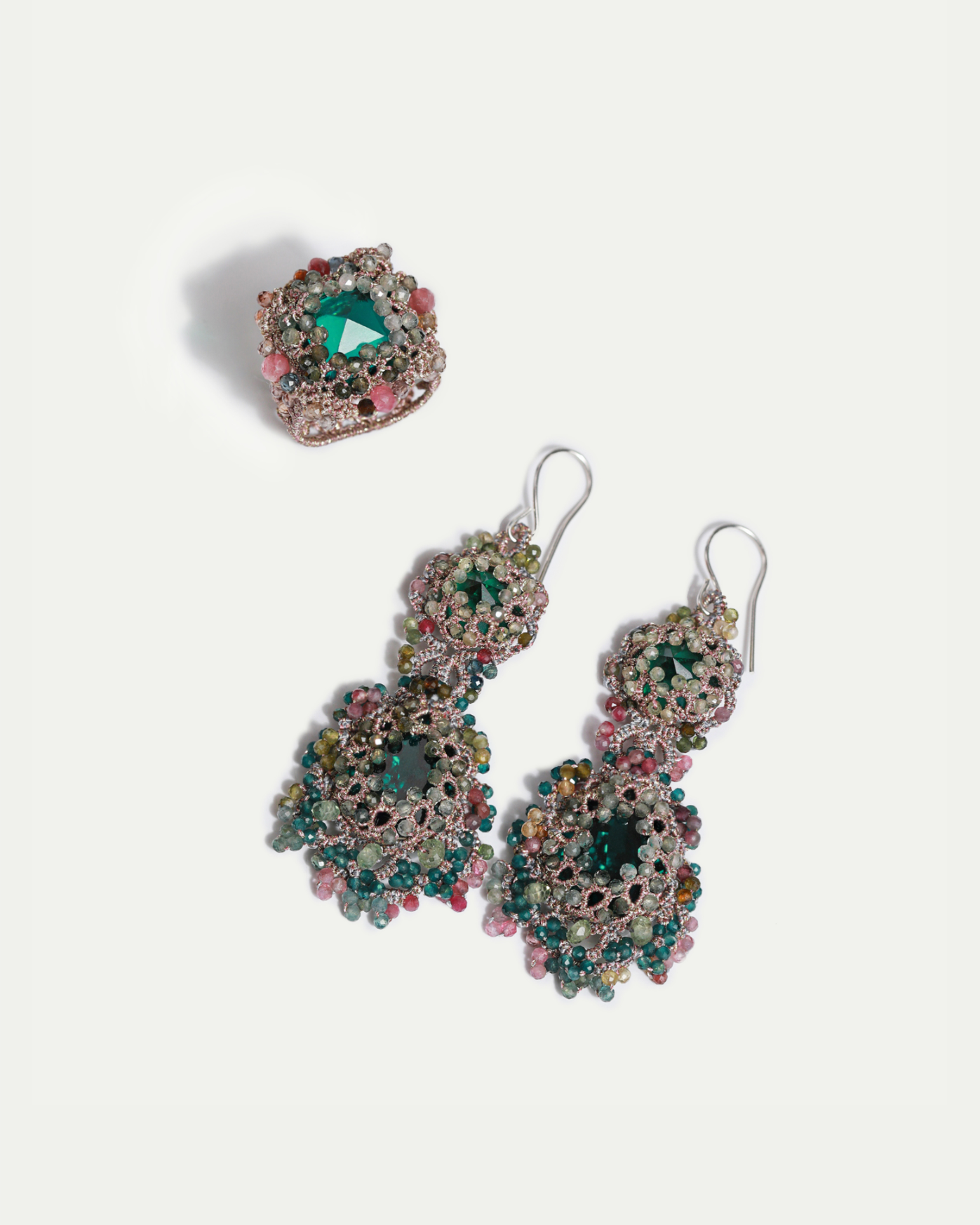Green silk earrings with intricate multicolor bead details, featuring a prominent central gem.
