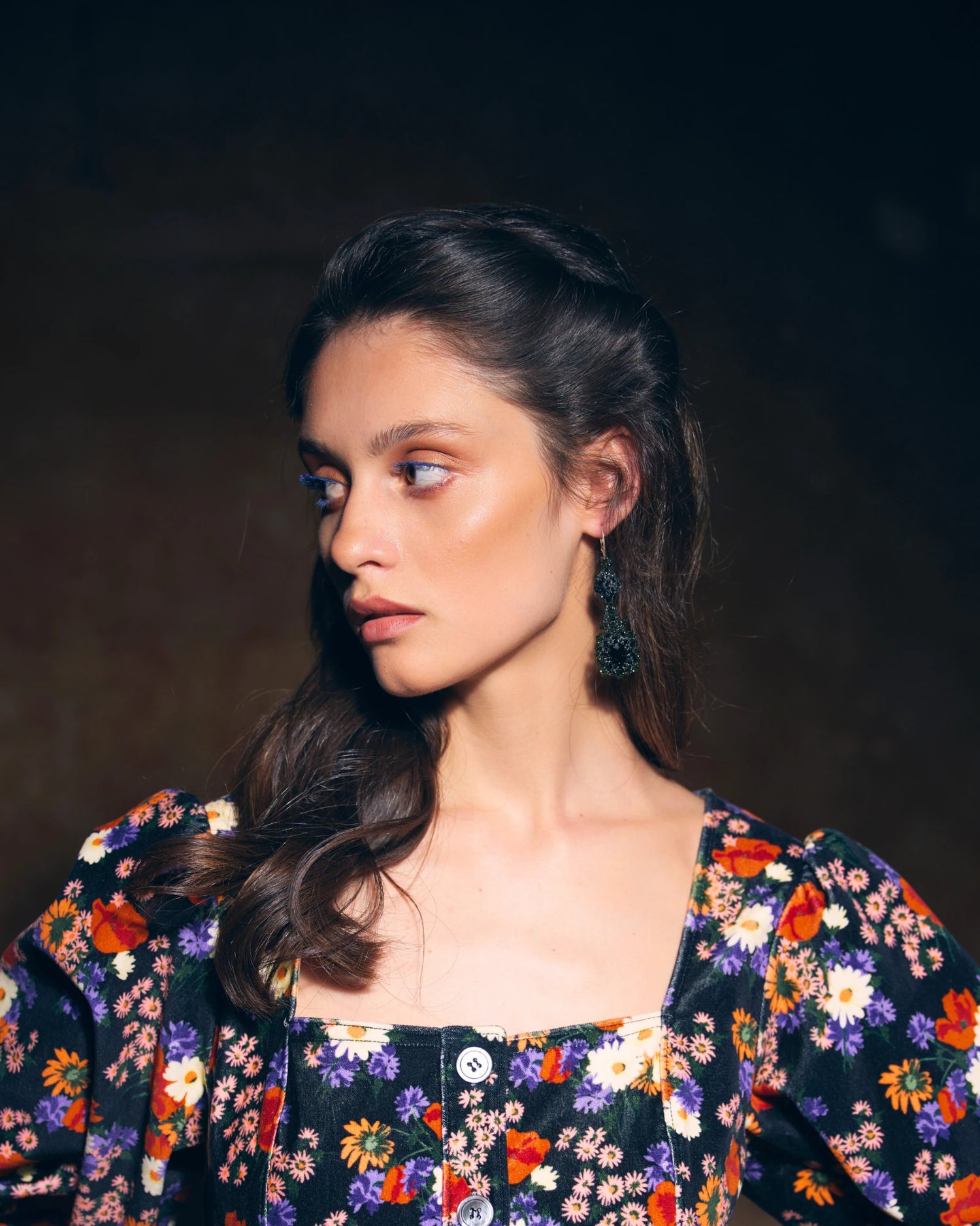 Eloise Earrings featuring black crystal, spinel, silk threads, and silver hooks worn by model.