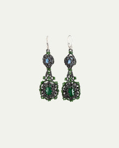 Black Eloise earrings with green and blue stones, intricate bead detailing, silver hooks, side view angle.