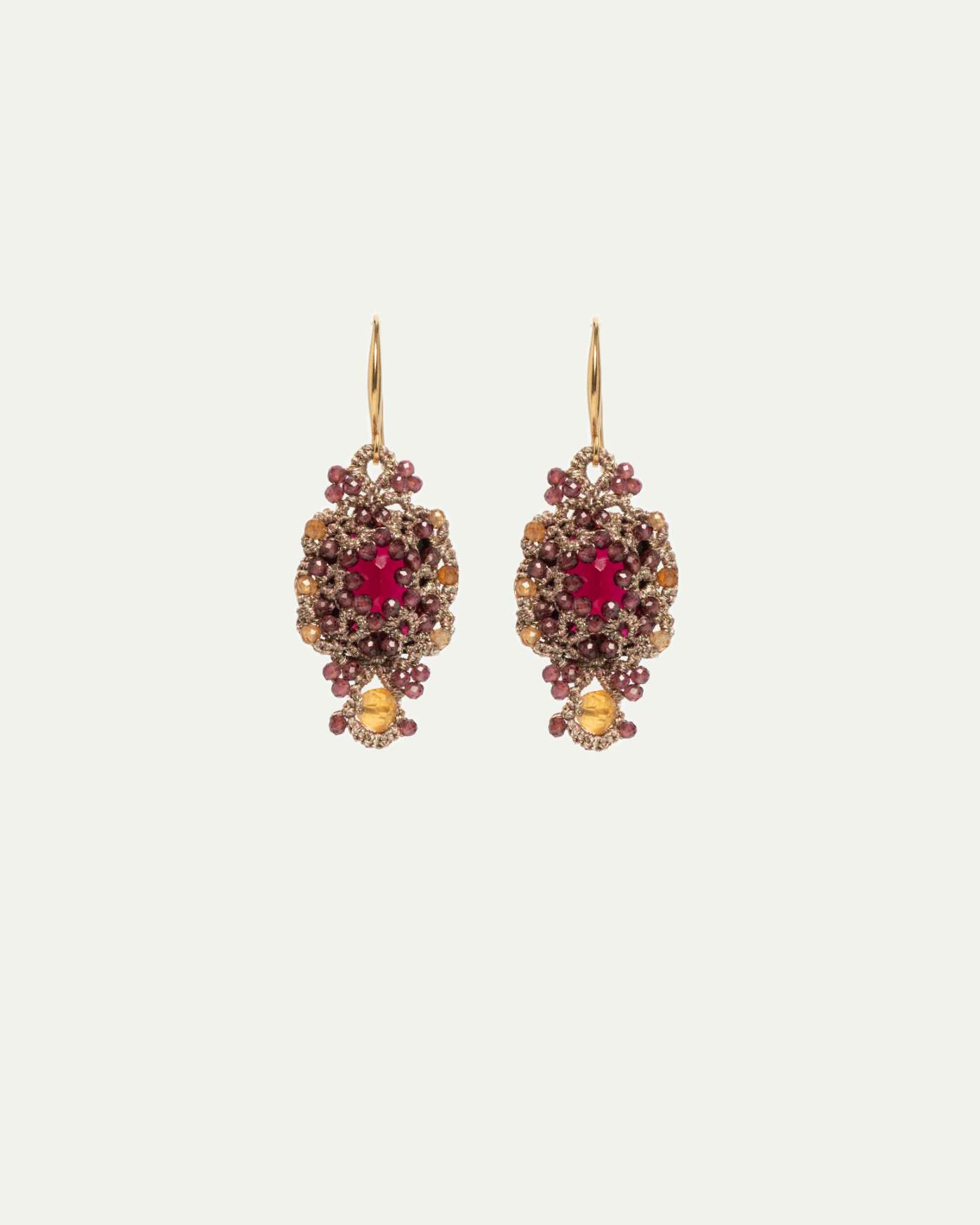 Gold-plated silver earrings with red and yellow gemstones, silk threads, and crystals.