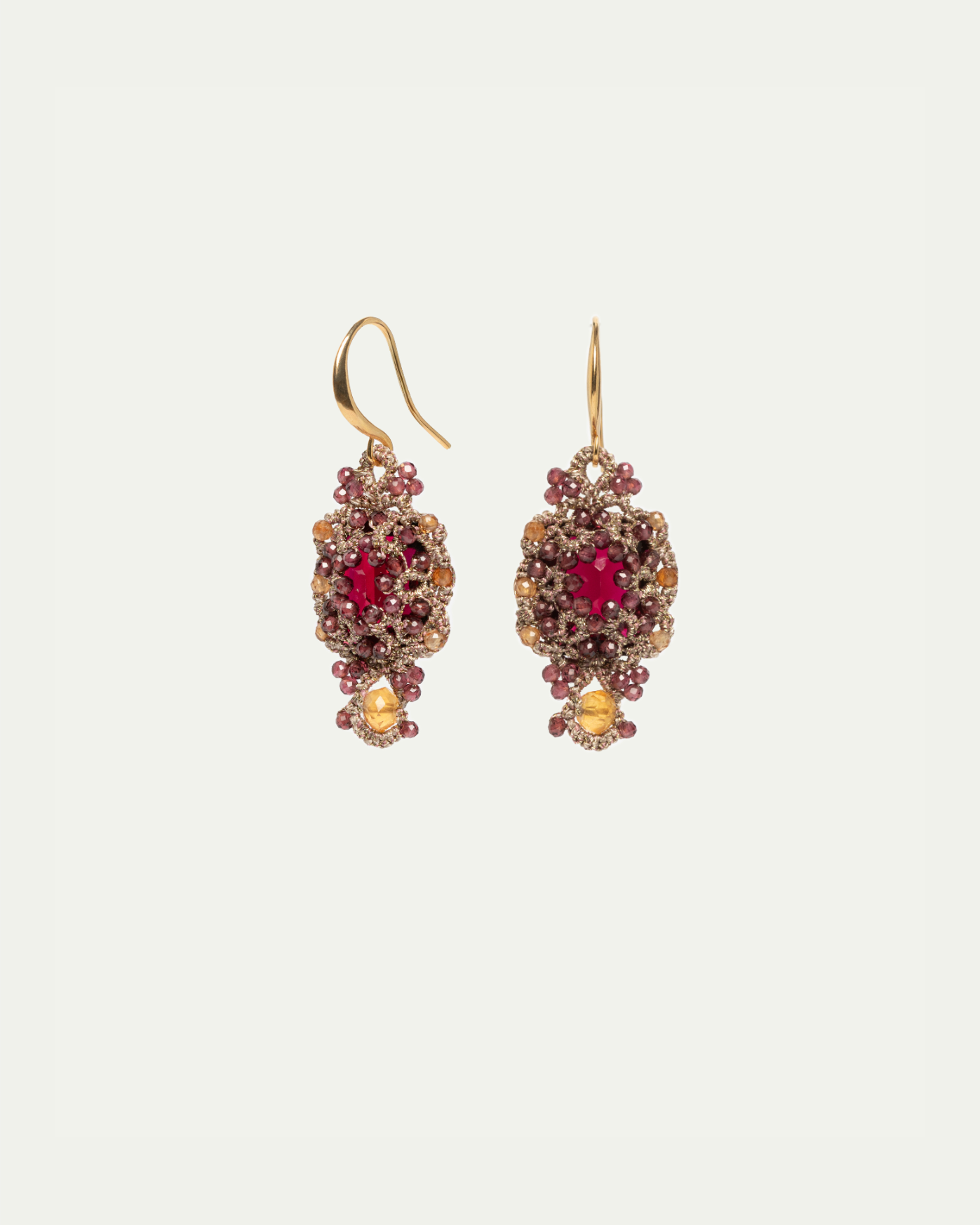 Gold and red silk earrings with intricate bead detailing and a teardrop design.