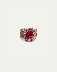 Gold ring with intricate red gemstone cluster setting, featuring a large central red gem.