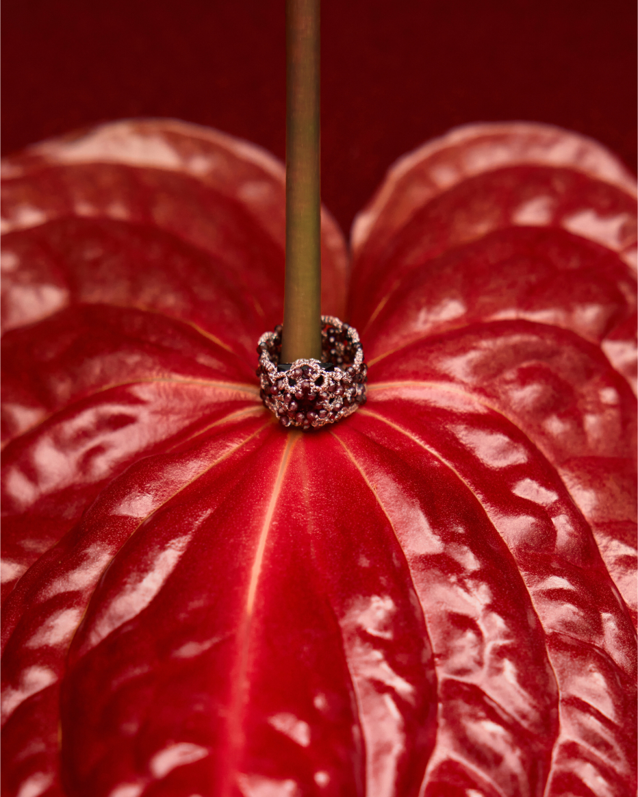 ESTELLE RING with crystal, garnet gemstones, silk threads on red background.