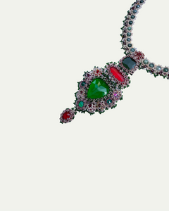 Garnet, sapphire, and pearl necklace with silk and crystal detailing, featuring vibrant red and green stones.