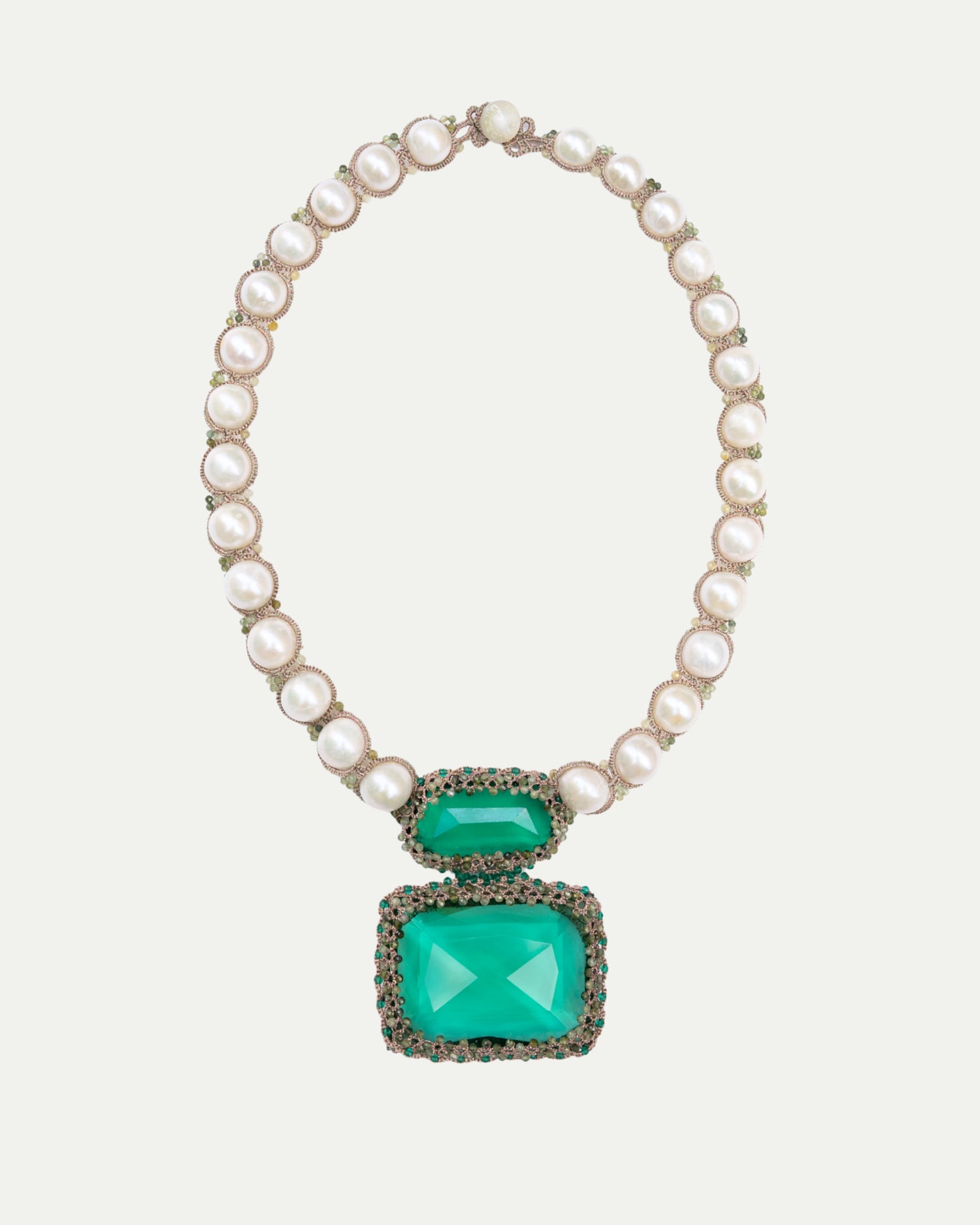 Necklace with pearl chain and green gemstone pendants on a white background