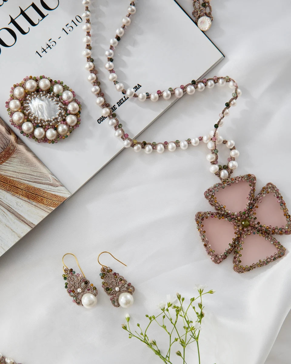 GEORGIA PENDANT with freshwater pearls, tourmaline, rose silk, mother of pearl button, glass, and metallized threads.