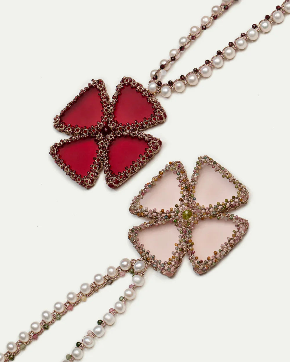 Silk and pearl necklace with rose tourmaline clover pendants, adorned with freshwater pearls and detailed beading.