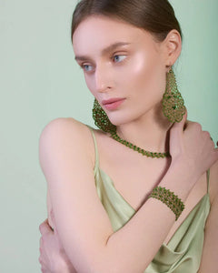 Green silk and gold Gerbera earrings with intricate floral design detailing.