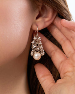 Silk silver earrings with white freshwater pearls and intricate texture details.