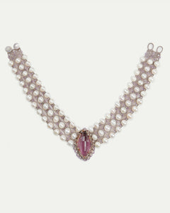 Rose gold necklace with pearls and a central amethyst pendant in a side view, intricate detailing.